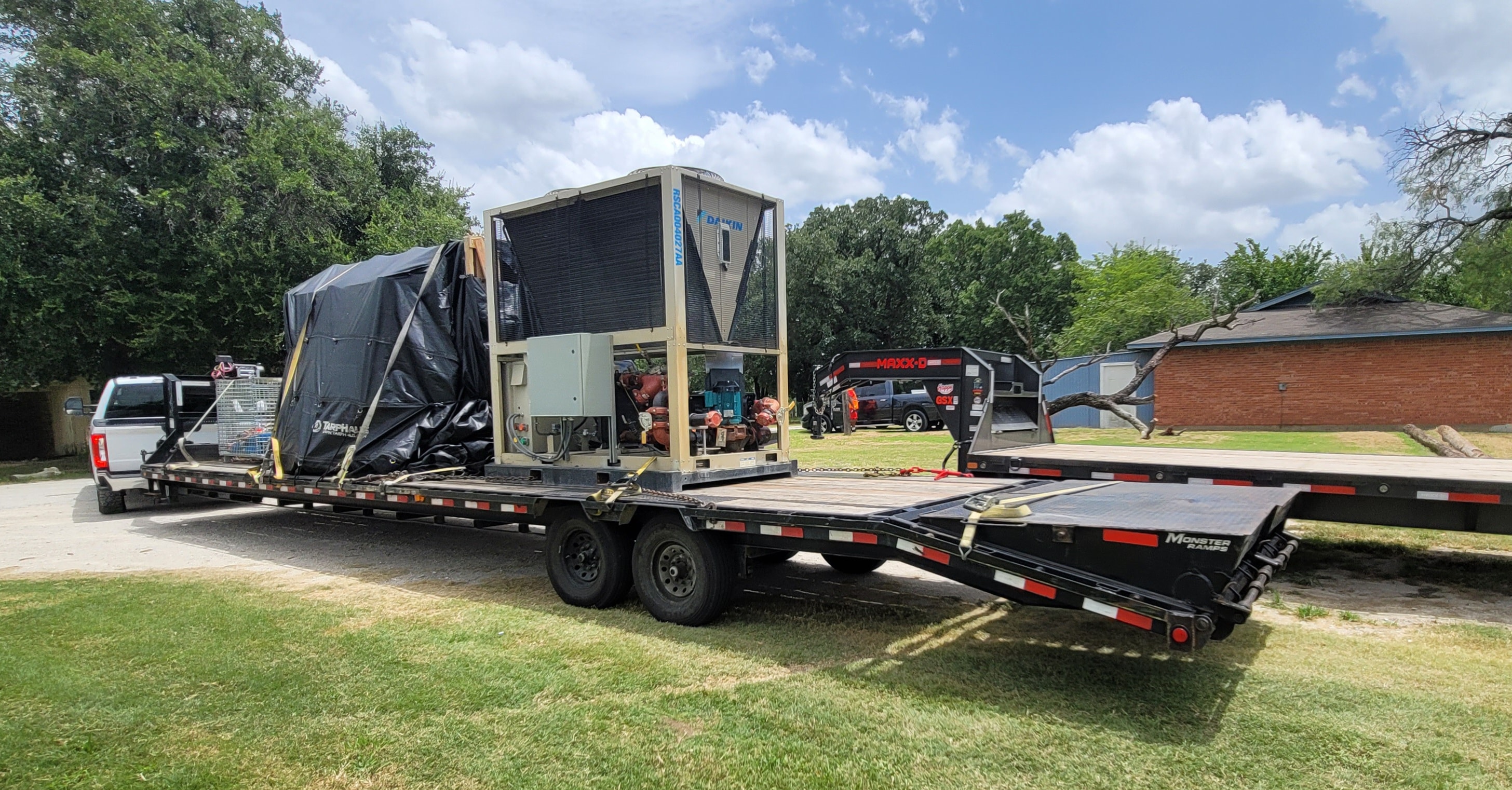 HVAC unit and equipment loaded on gooseneck flatbed trailer